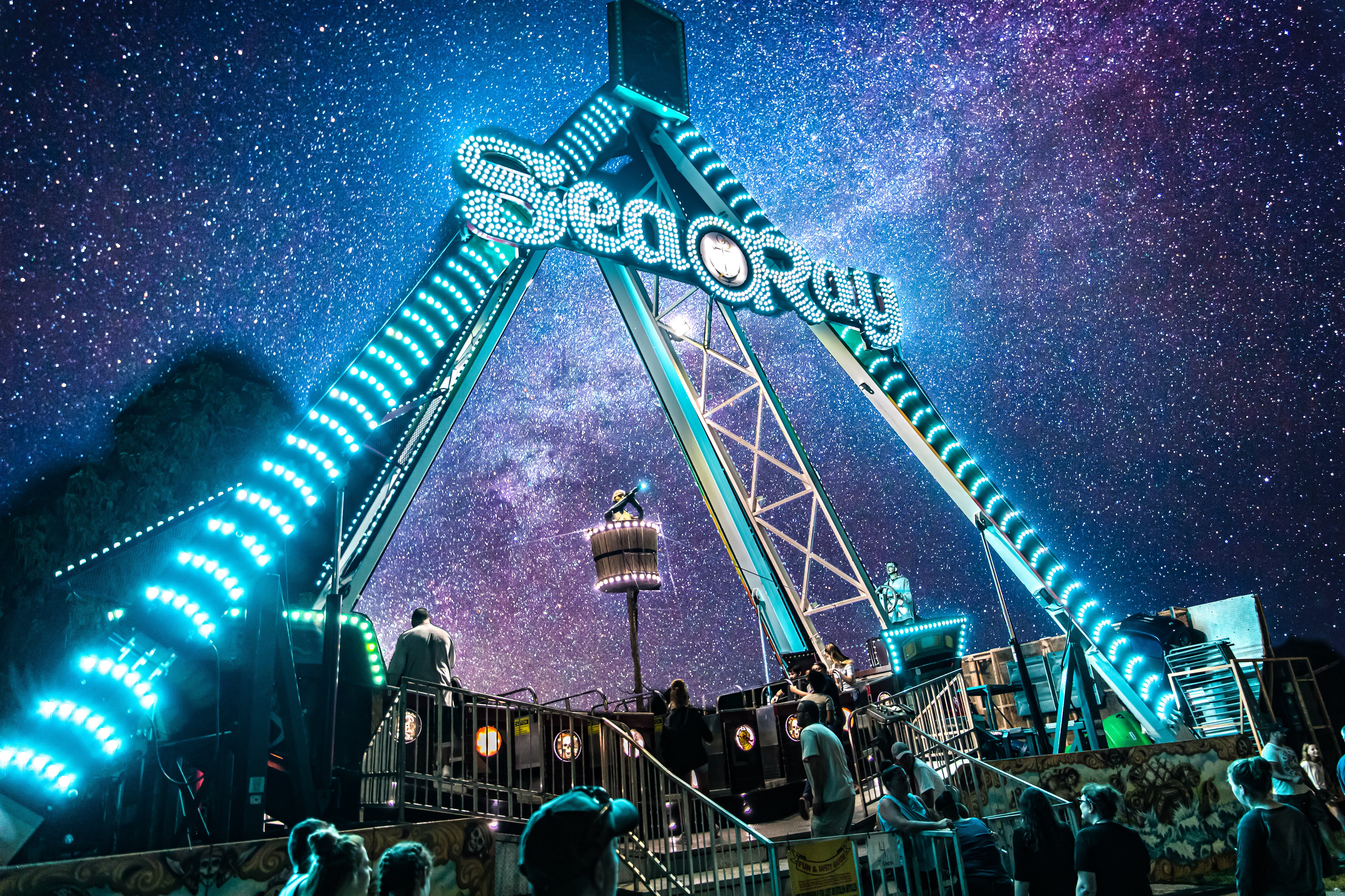 An illuminated carnival ride at night